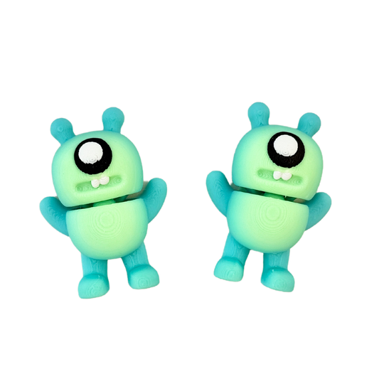 Adorable alien monster fidget toy featuring black and white googly eyes, flexible body, and a spooky yet cute design.