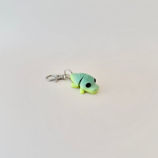 Small crocodile fidget toy in green shades, attached to a keychain for versatile use.