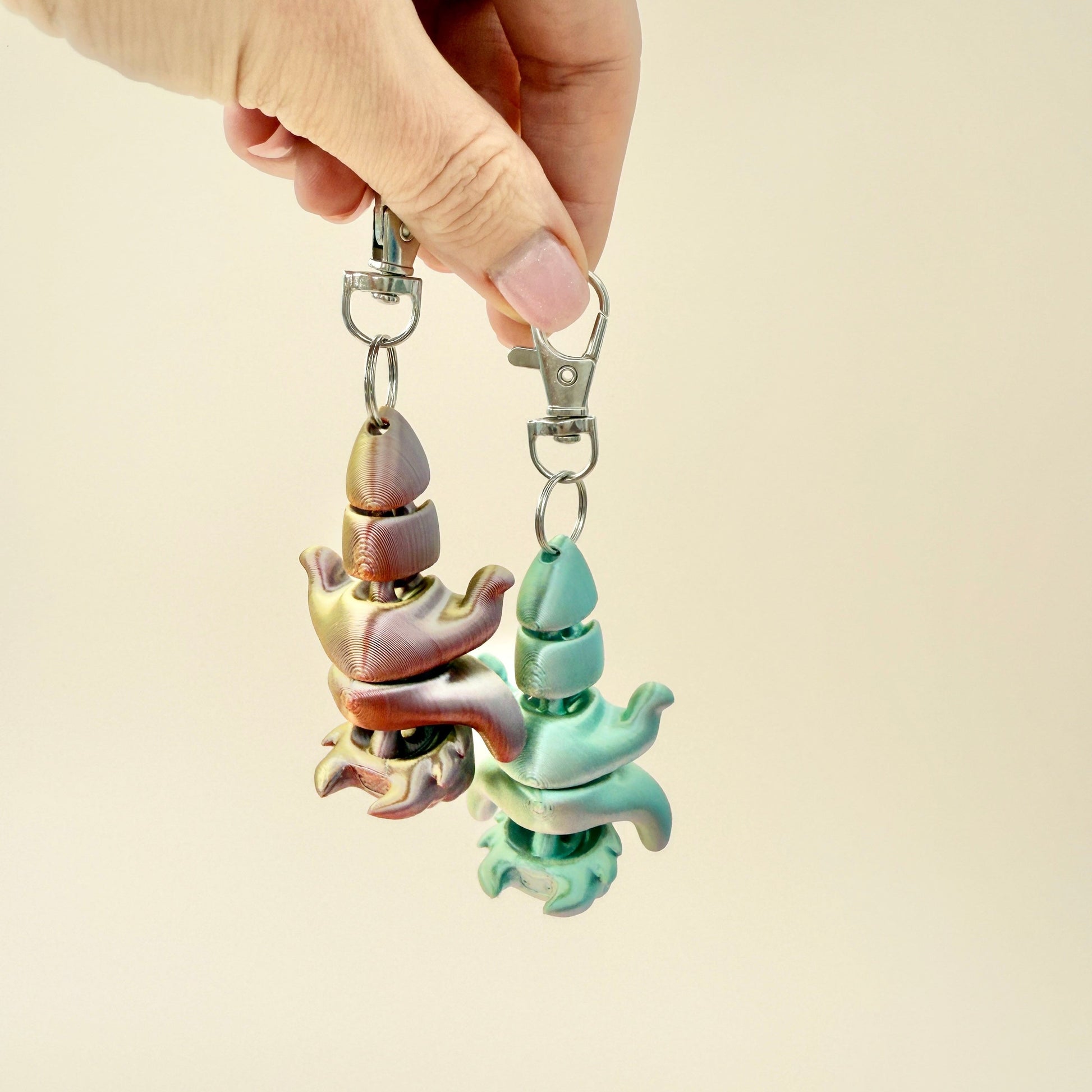 8cm dragon keyring in silver or bronze hues with a fully articulated design for sensory play.