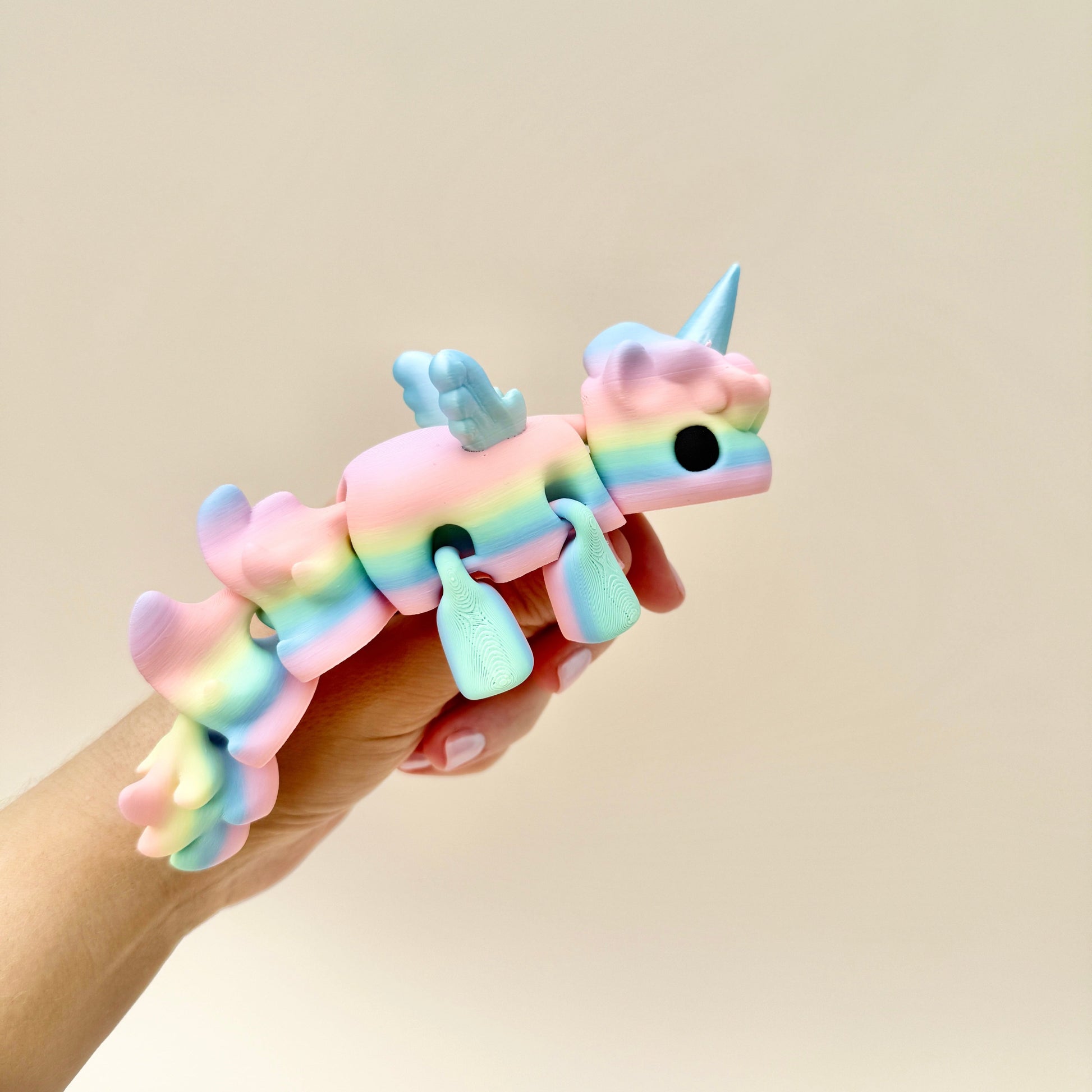 Large Unicorn fidget toy featuring flexible movement and vibrant rainbow colours with shiny details.