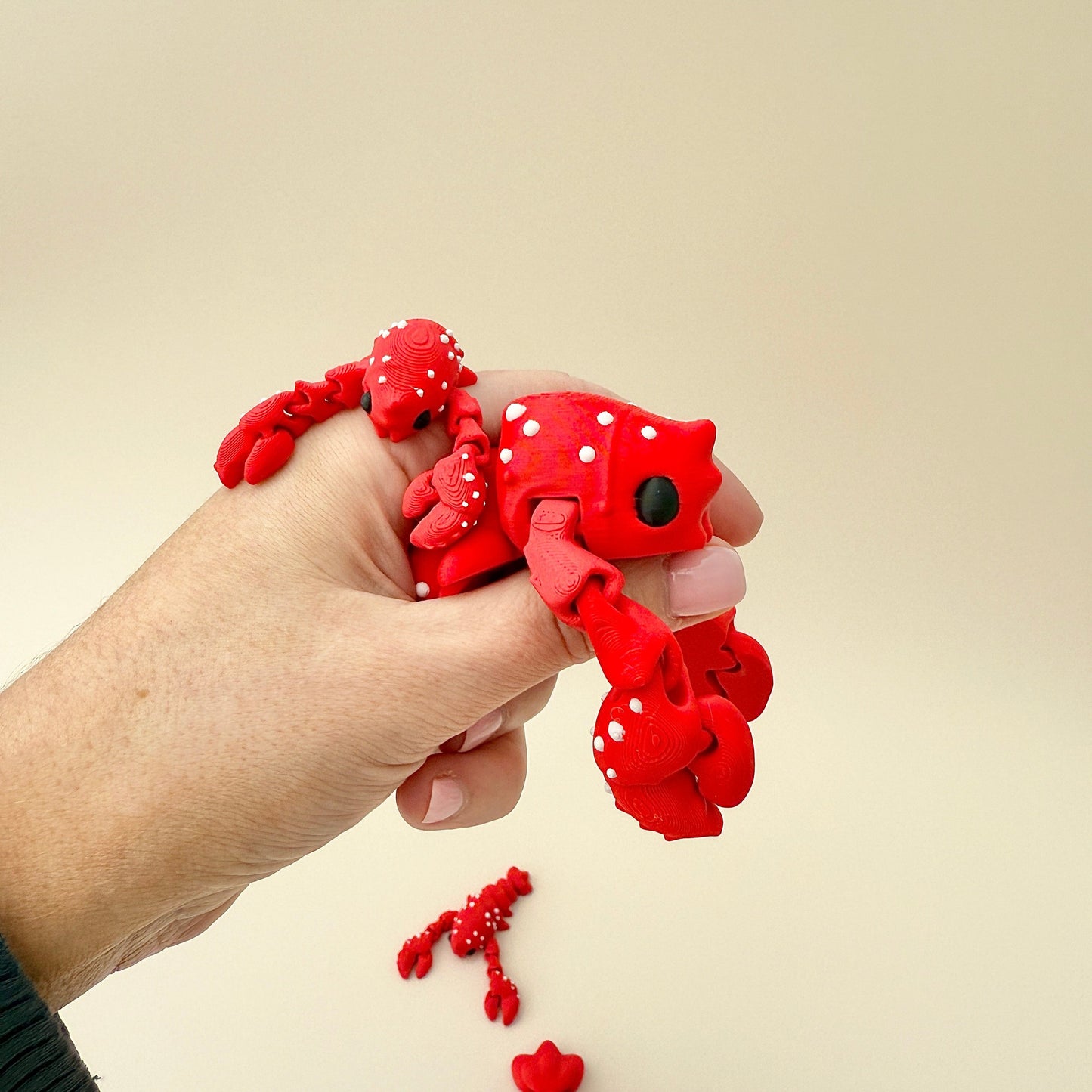 Bright red lobster fidget with white dot details and black eye, perfect for sensory engagement.