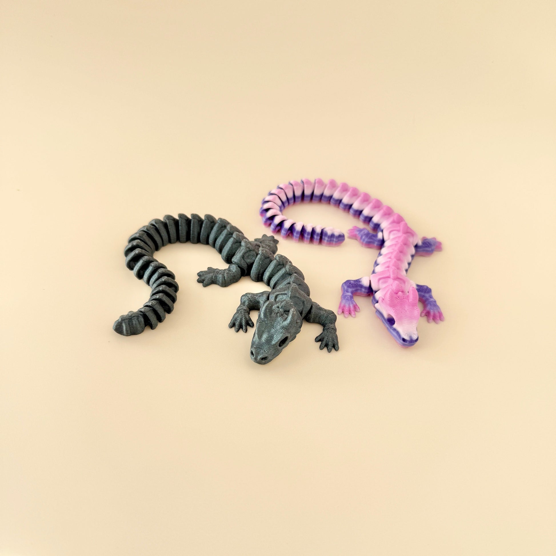 Fully articulated Skeleton Dragon fidget toy available in galaxy black or purple gradient finishes.