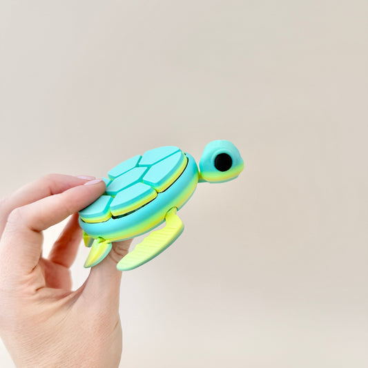 Large turtle clicker toy featuring a green and blue colour gradient, fully articulated and perfect for sensory play.