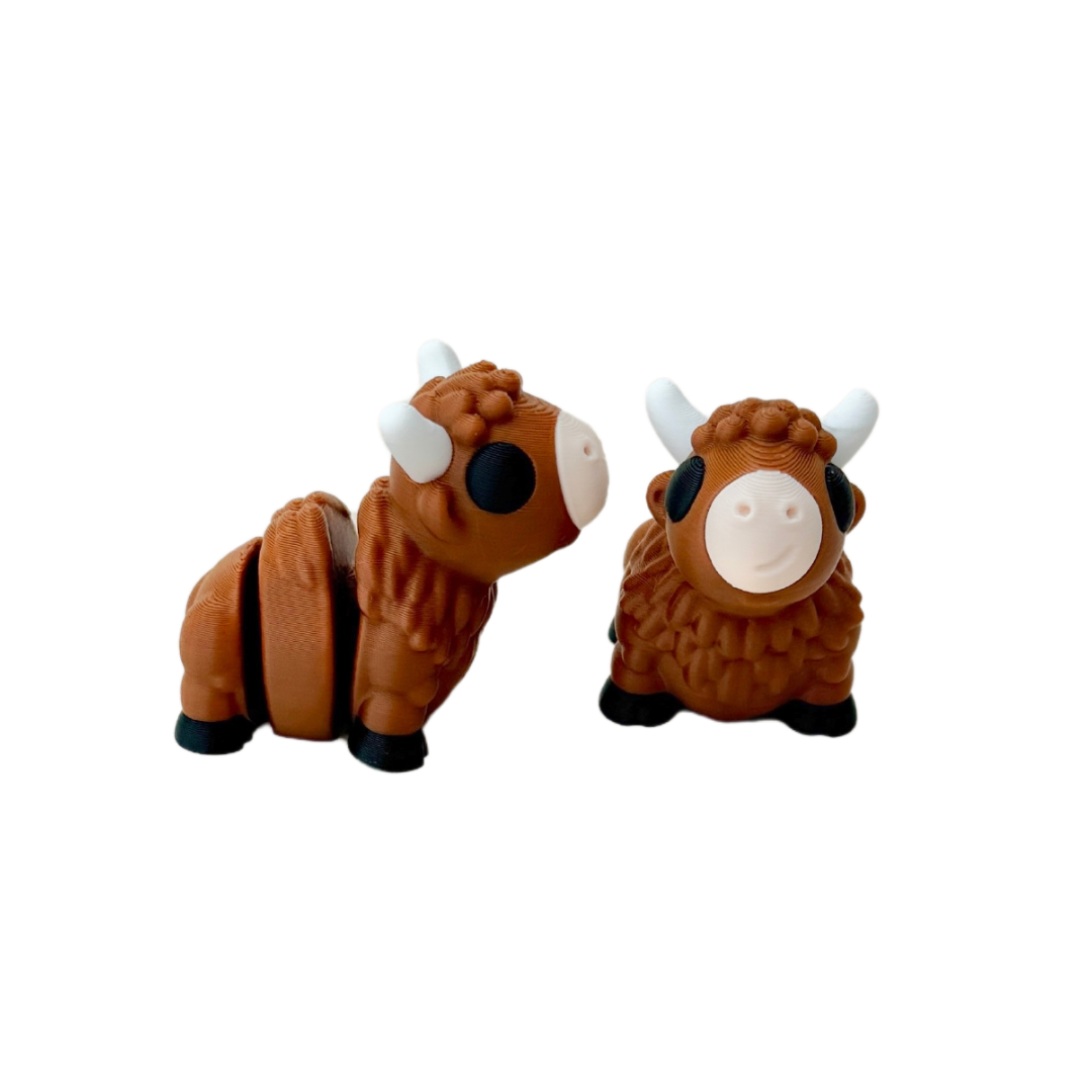 Bison fidget toy with brown furry finish, white horns, black eyes and hooves, and nude mouth, 5cm in size.