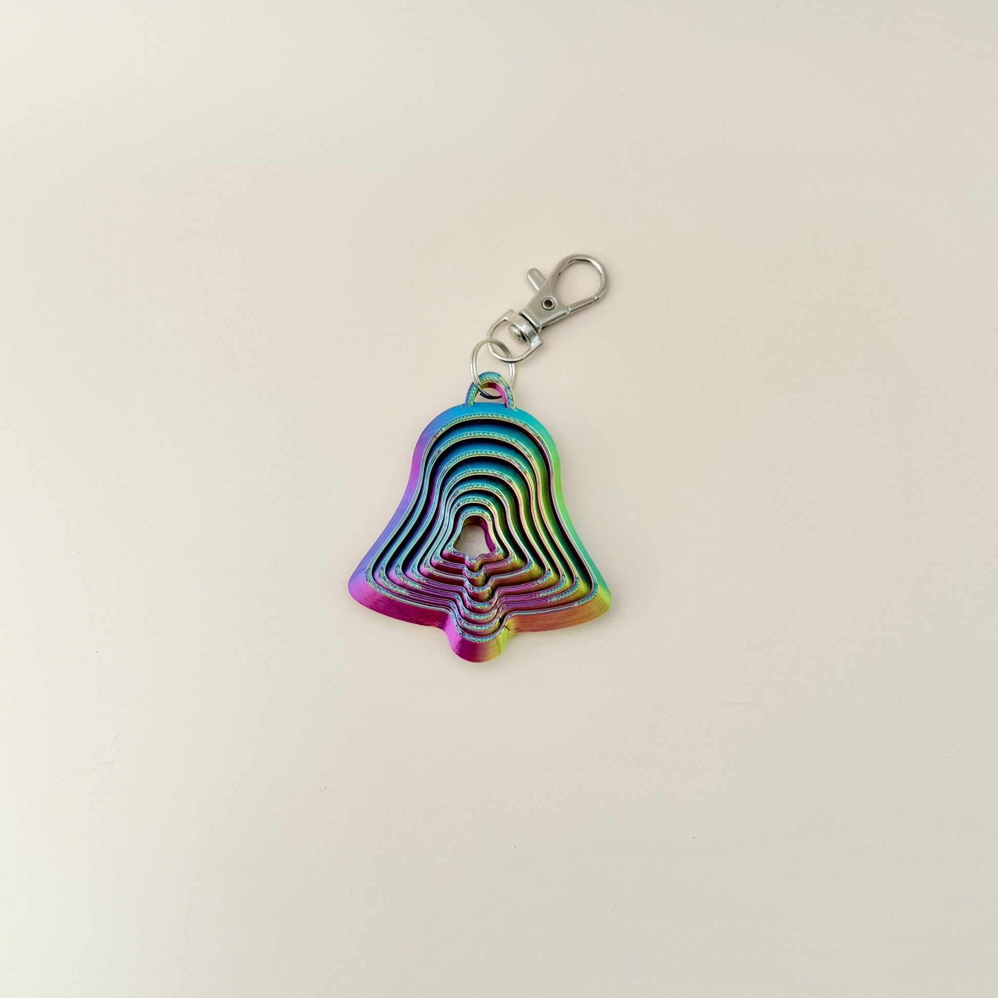 Colour-changing Christmas bell fidget toy with keychain attachment for bags or keys.