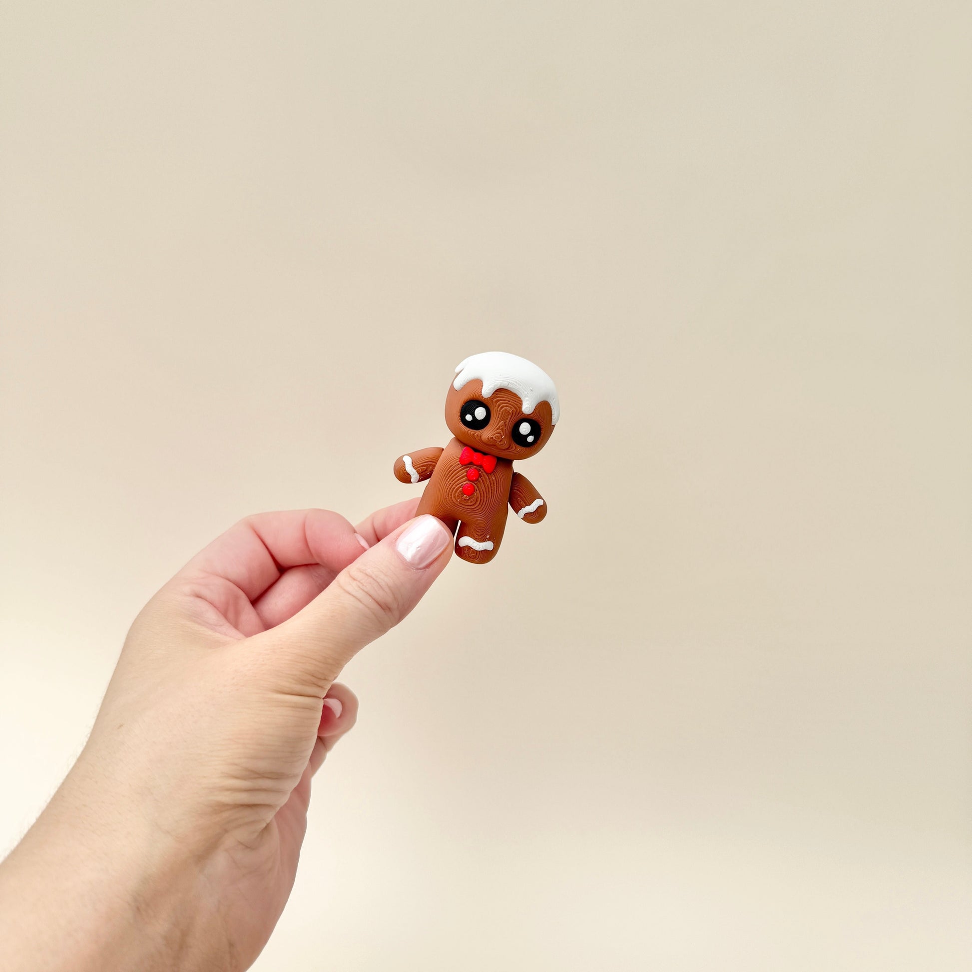 Fully moveable Gingerbread Friend fidget toy with detailed icing and festive design.