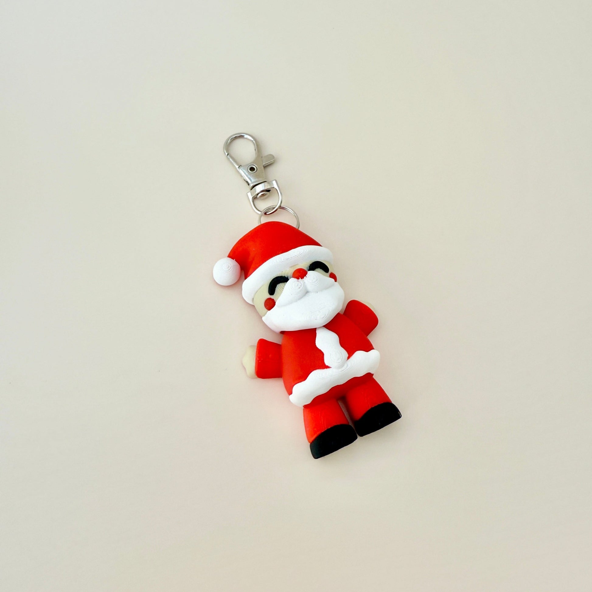 7cm Father Christmas keyring with a big beard, rosy cheeks, and a classic Santa hat.