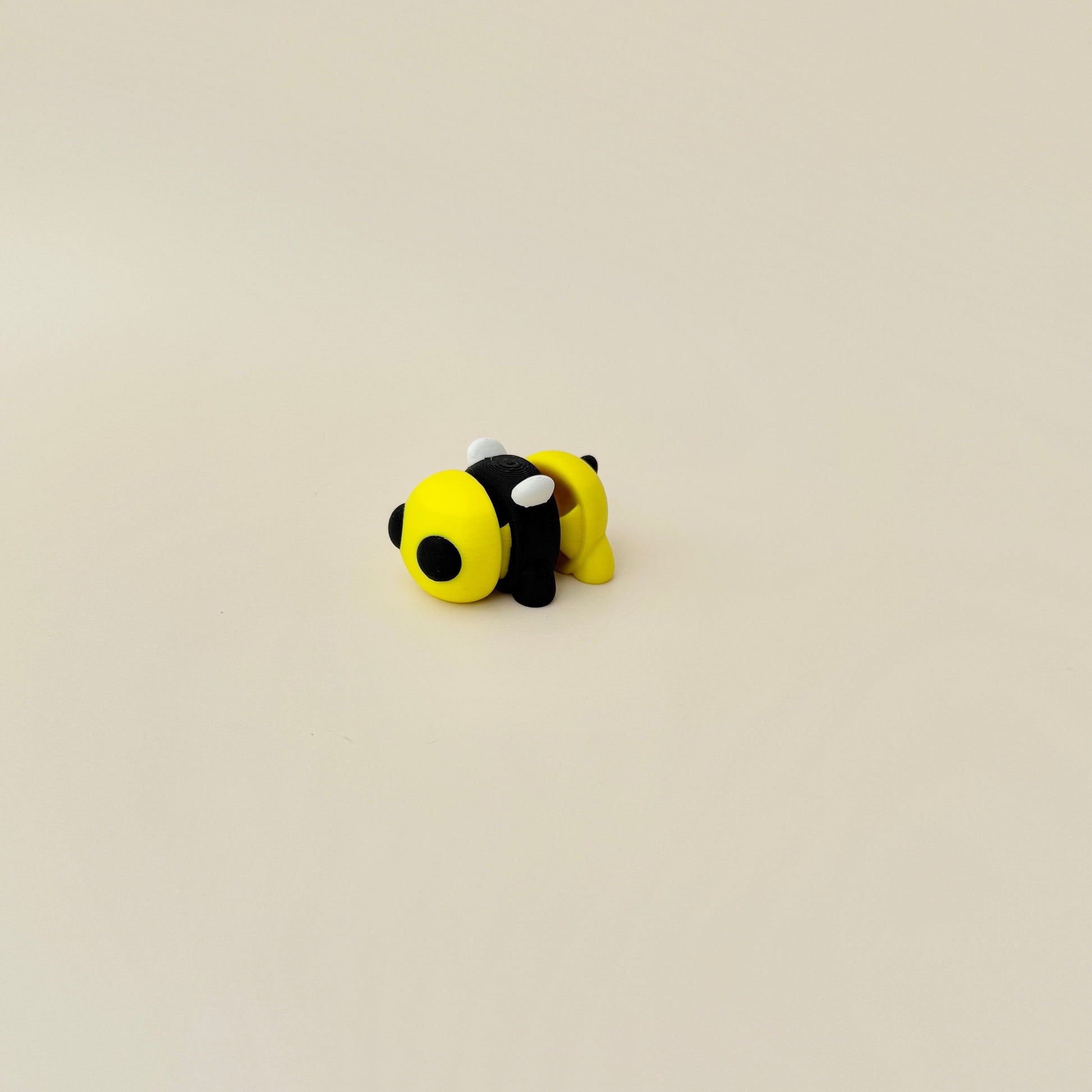 A charming bumble bee fidget toy featuring bright yellow stripes and articulated design.