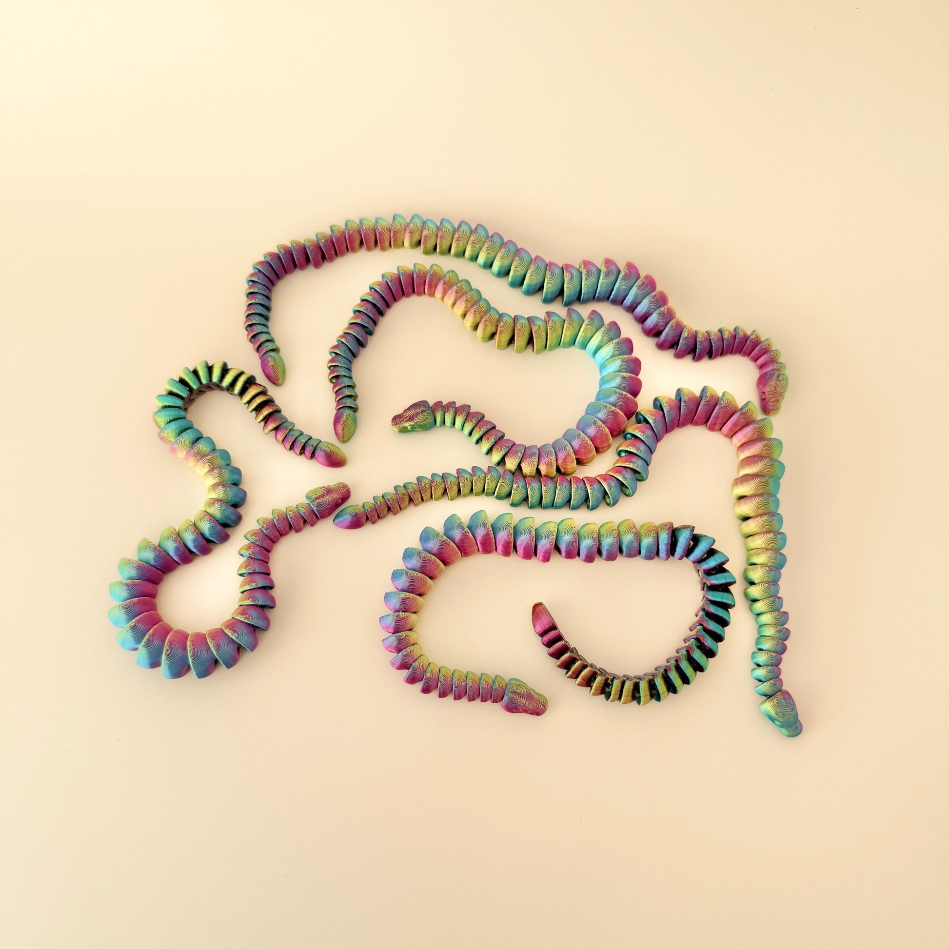 Colour-changing snake fidget toy with a dynamic filament and fully moveable design, perfect for fidgeting.