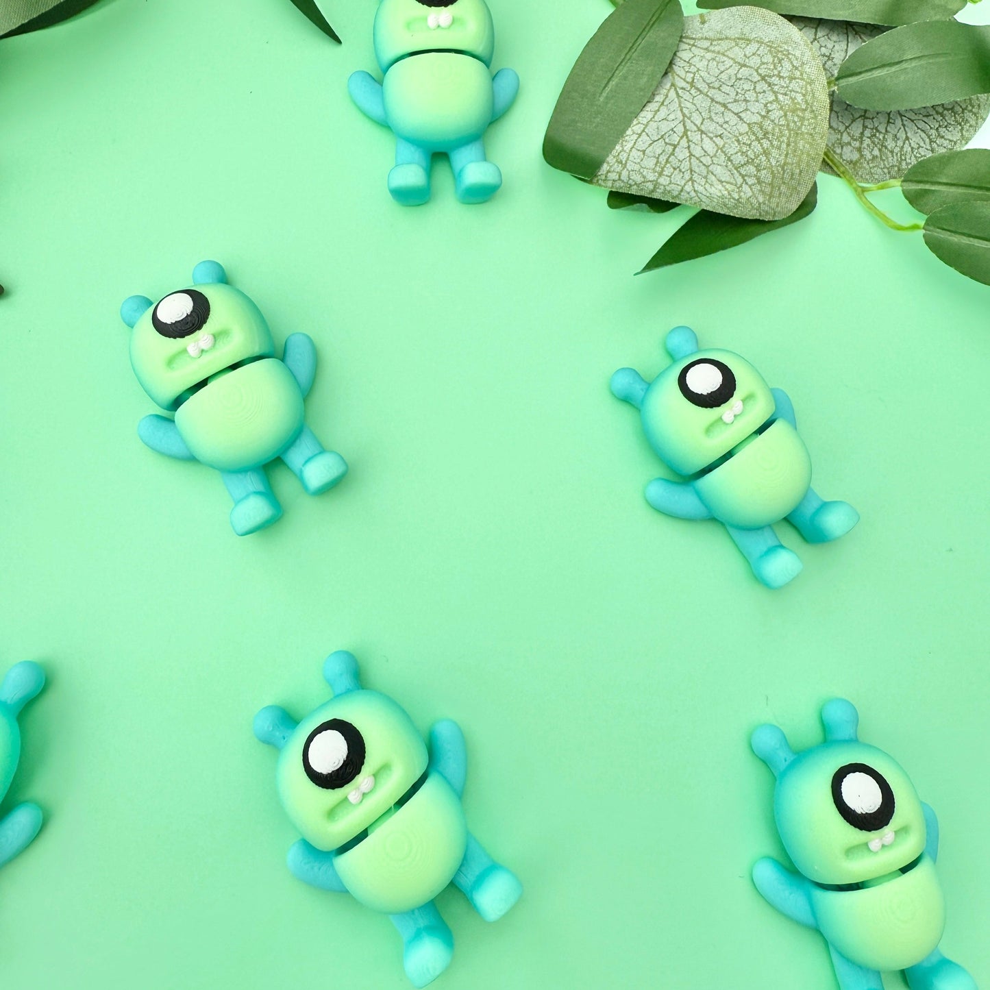 5cm alien monster fidget toy in blue and green with googly eyes and alien ears, designed for fun sensory play.