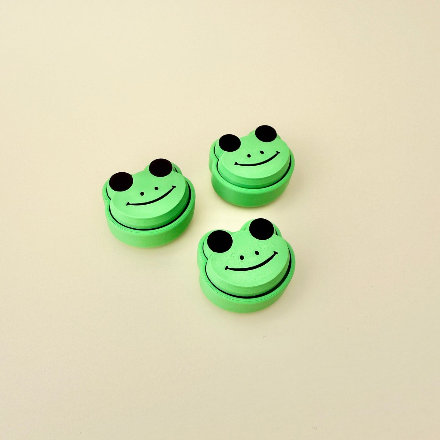 Adorable green frog fidget toy with click action, designed for sensory engagement and stress relief.

