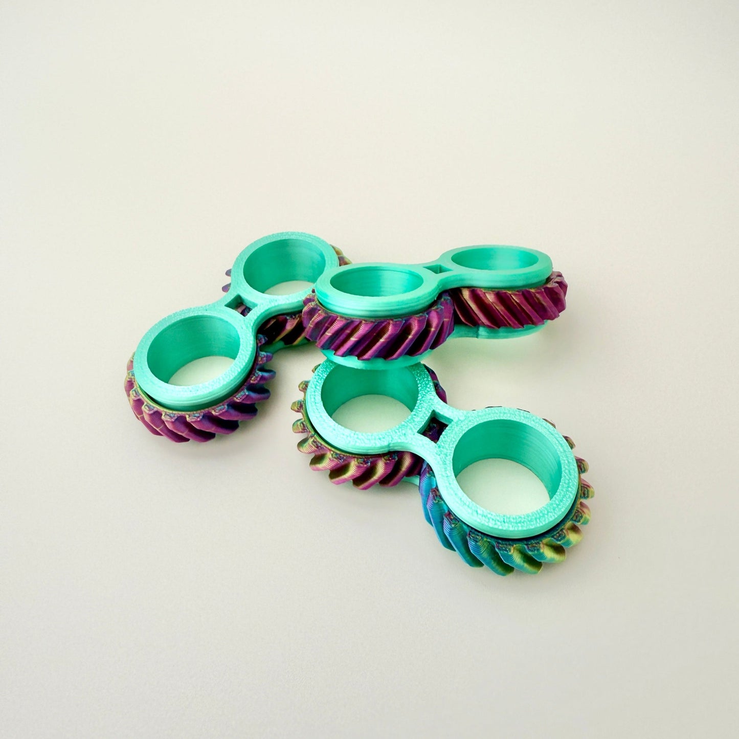 Interactive Twist & Roll fidget toy that slides onto fingers, available in multiple colours.