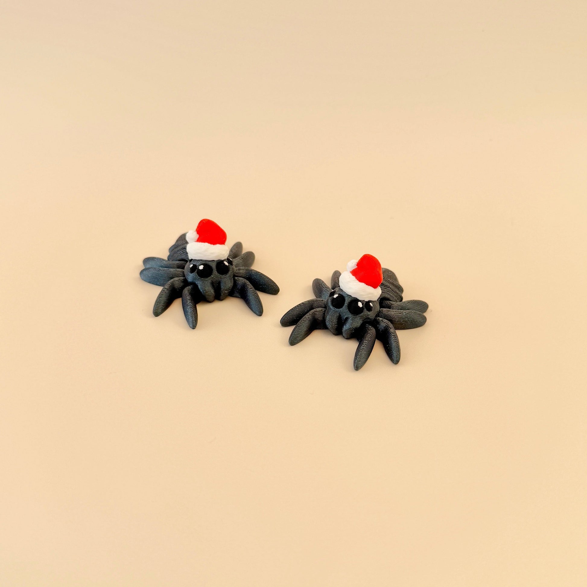 Christmas spider fidget toy with sparkly midnight-themed colours and 4 black and white eyes.