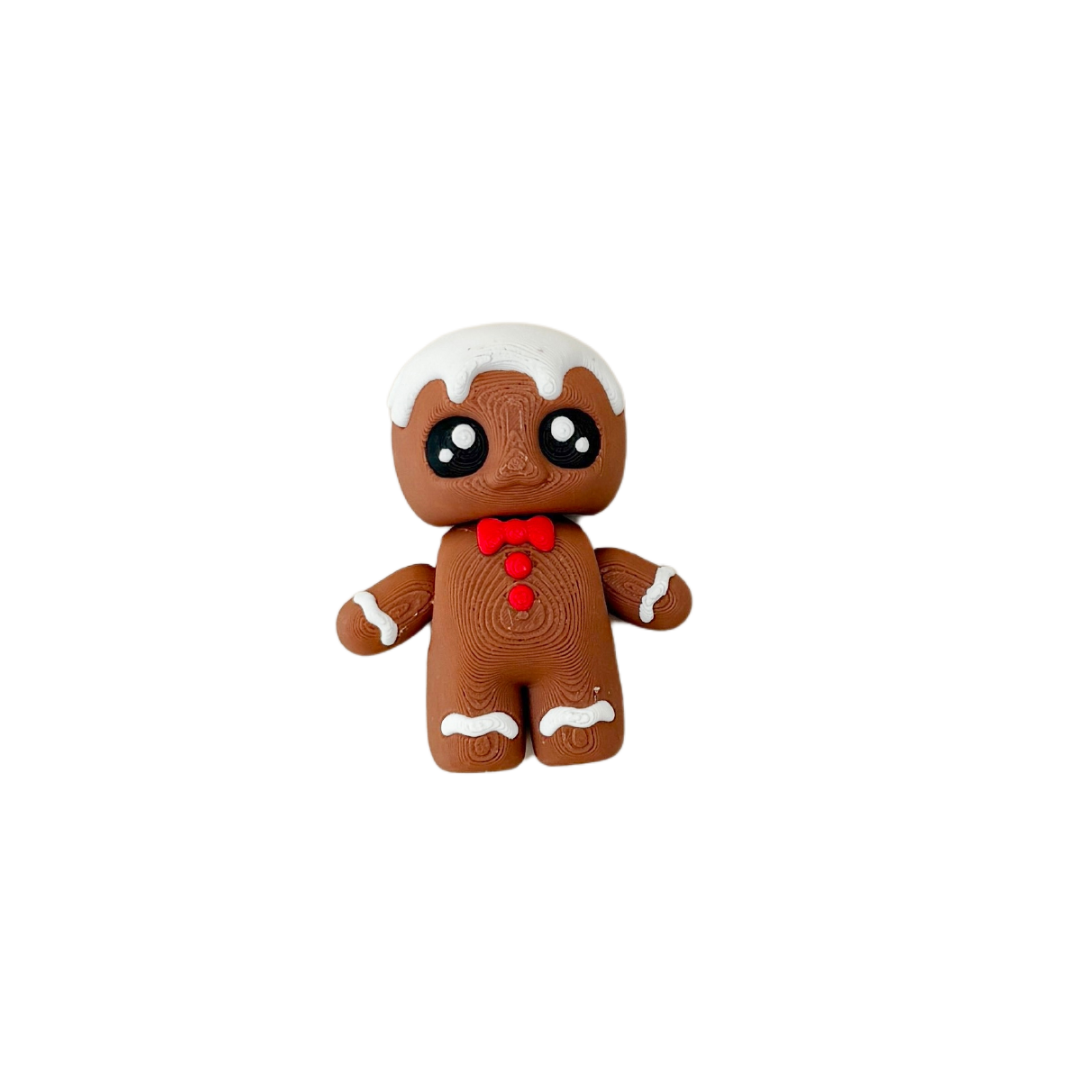 Gingerbread Friend fidget toy with brown body, white icing details, red bowtie, and black and white eyes.