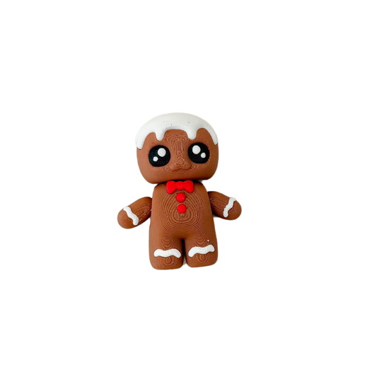 Gingerbread Friend fidget toy with brown body, white icing details, red bowtie, and black and white eyes.