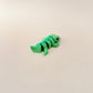 Realistic crocodile fidget toy with green body and spikey scales for smooth movement and sensory engagement.