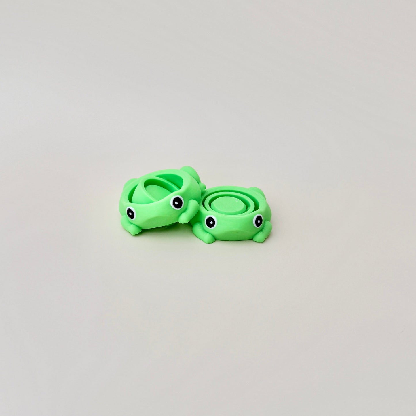 Frog fidget spinner with green body, small legs, and spinners in the middle, perfect for sensory play.