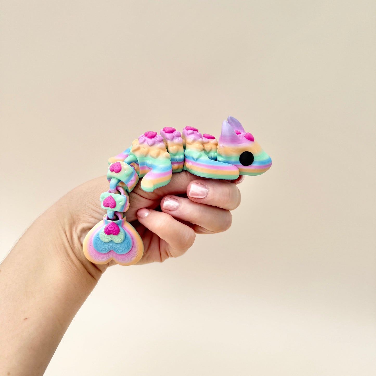 Rainbow Lovebug Dragon fidget toy featuring heart details and flexible articulation.