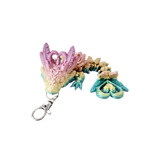 Heart Dragon Tadling keyring with shiny rainbow colouring and intricate details, including heart-shaped features.