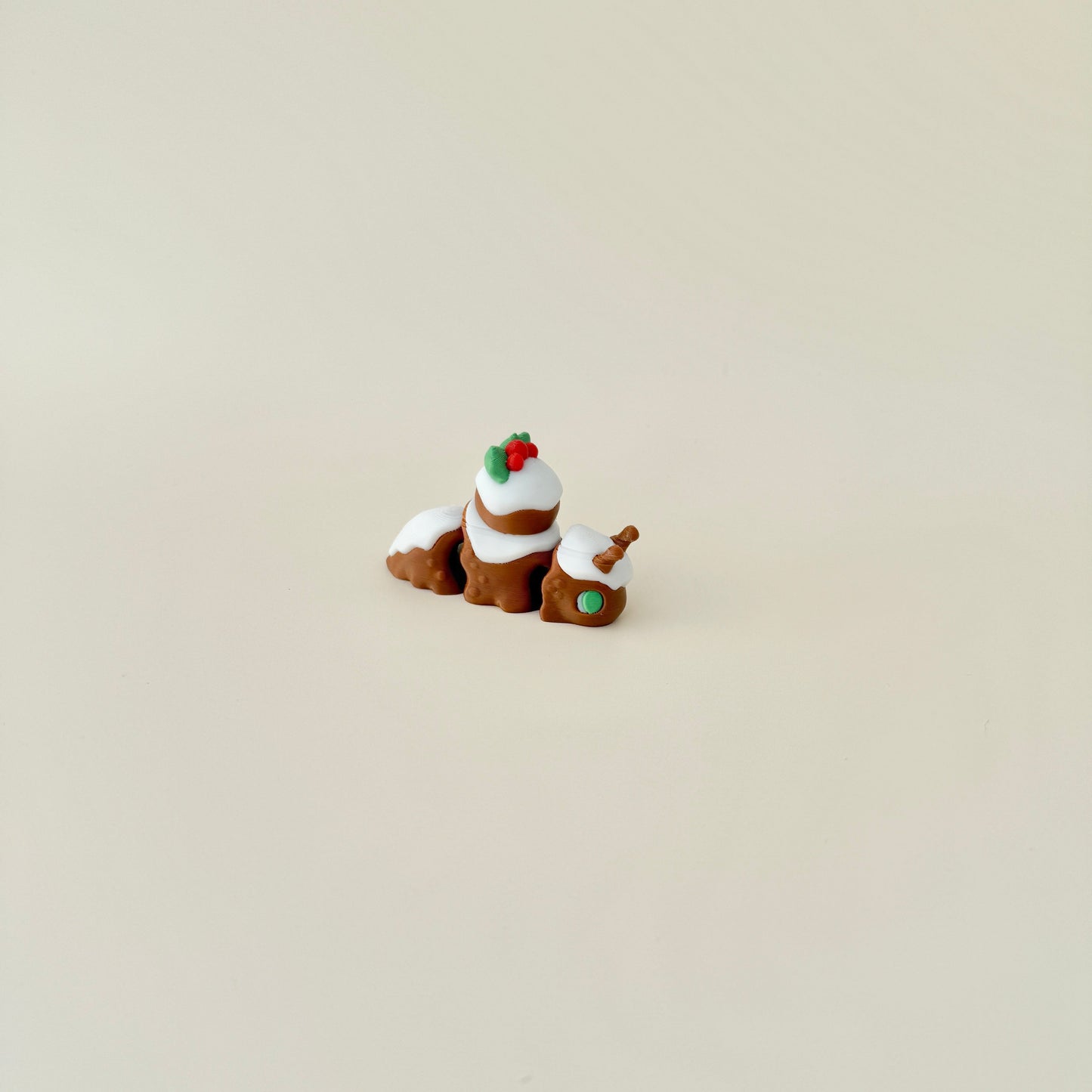 6cm Christmas pudding snail with festive details, including red and green holly and a fully flexible body.