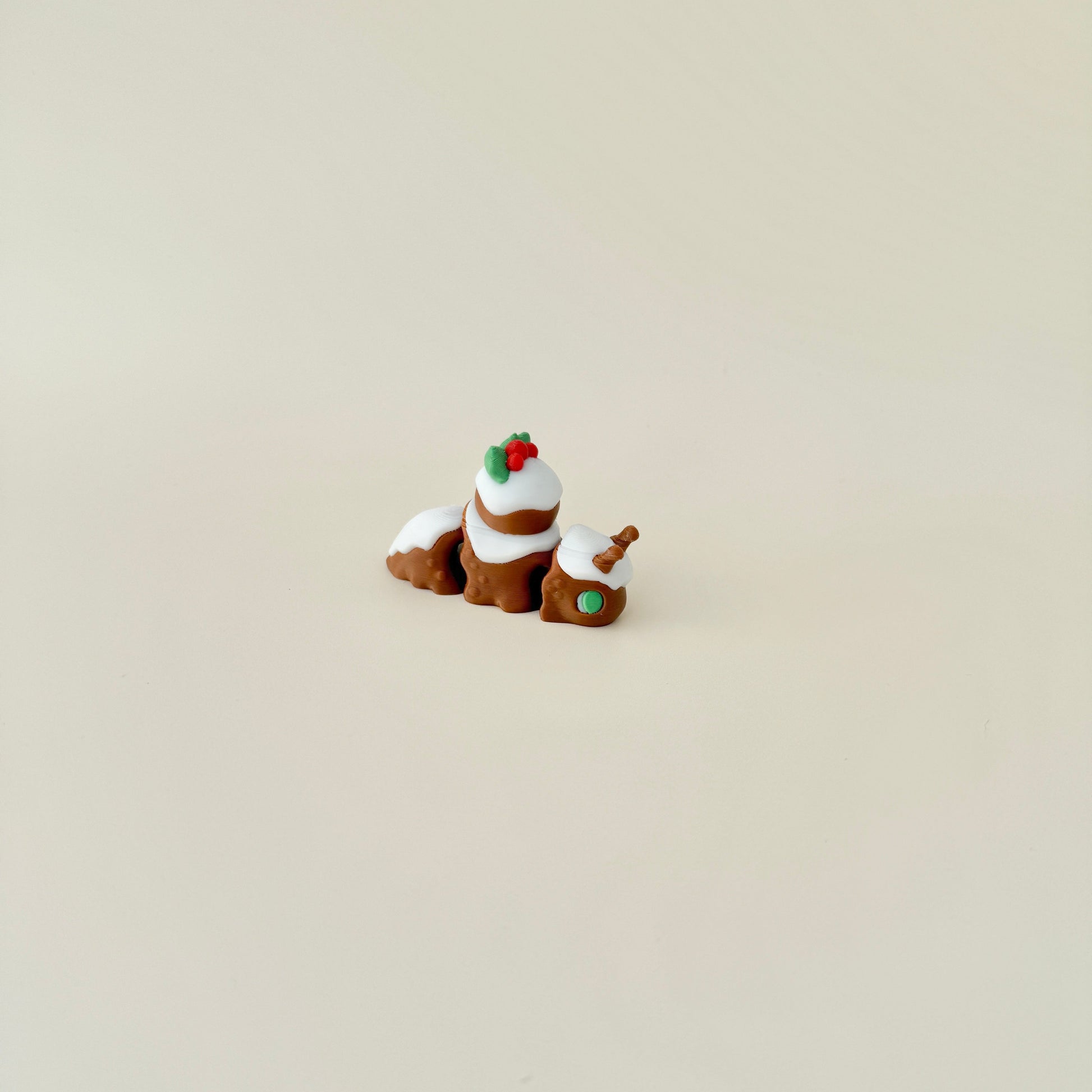 6cm Christmas pudding snail with festive details, including red and green holly and a fully flexible body.