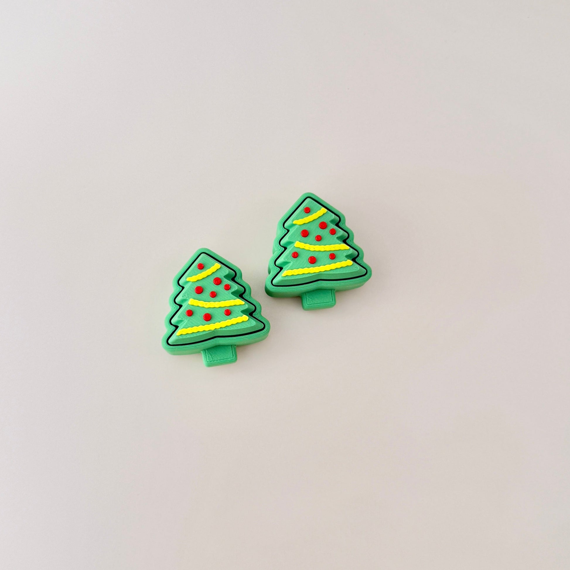 Miniature Christmas tree fidget toy with yellow tinsel and red baubles, great for stocking fillers.