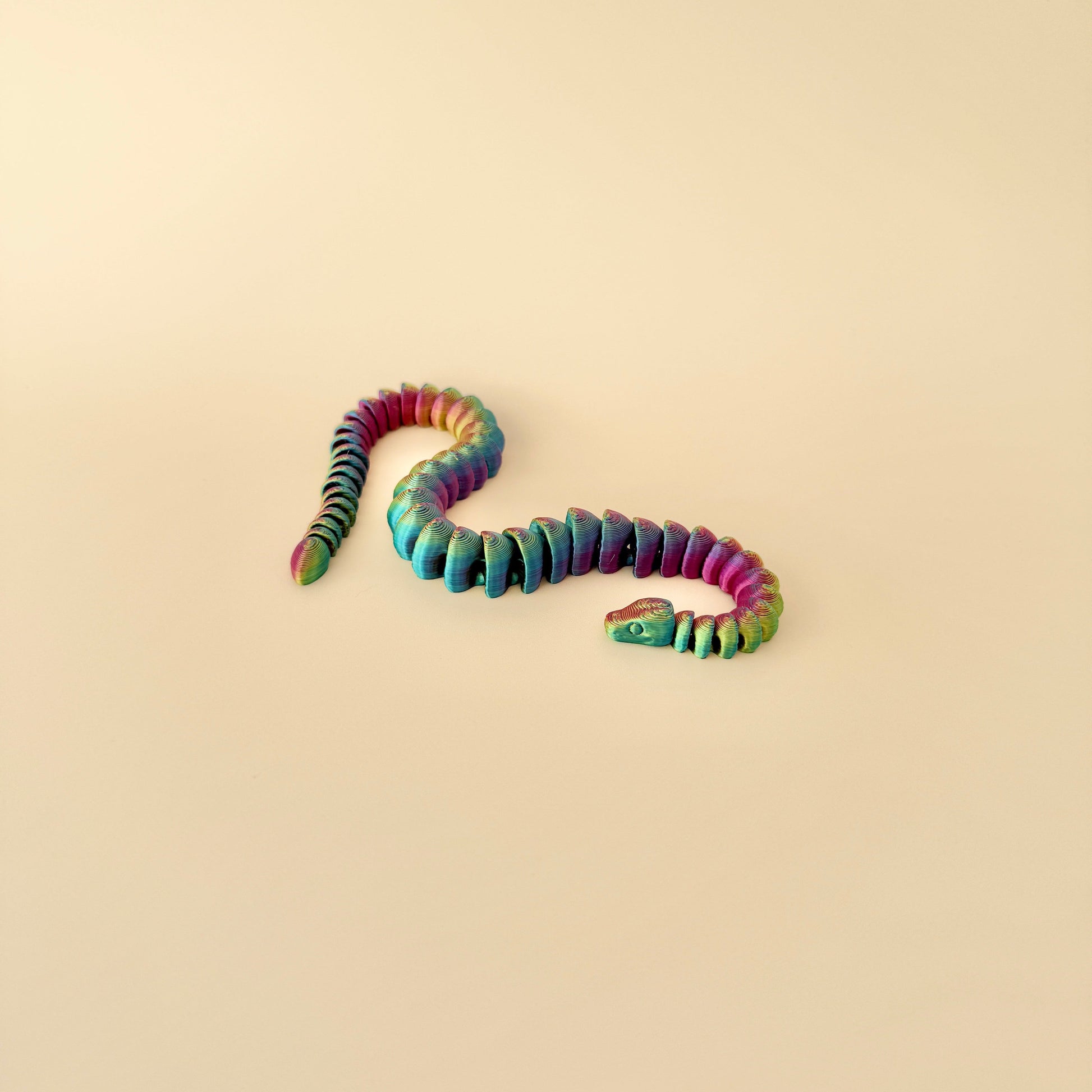 25cm snake fidget toy in a colour-changing filament, offering satisfying sensory engagement and movement.