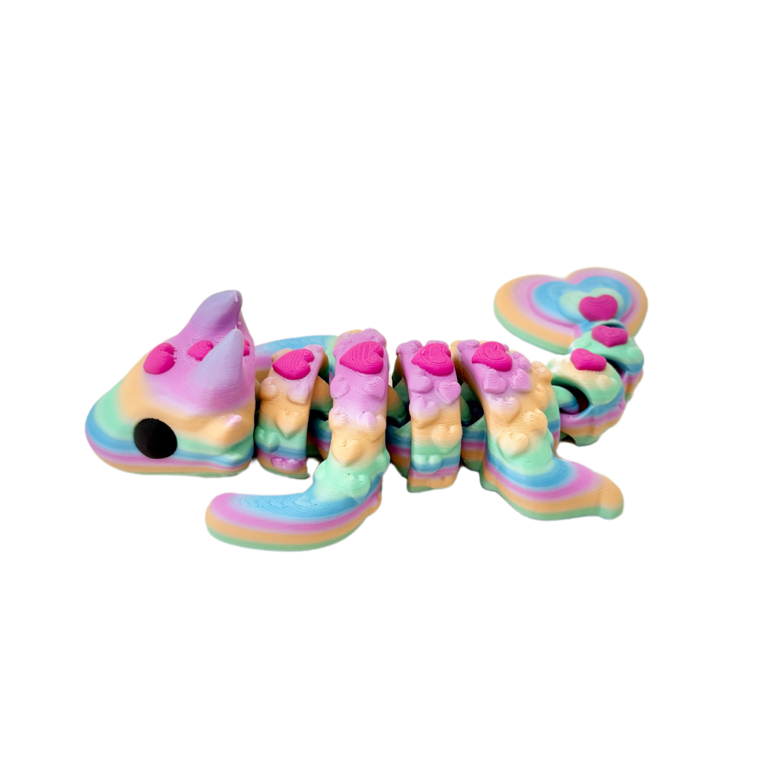 Lovebug Dragon fidget toy with a bright rainbow body and pink hearts, fully articulated for sensory play.