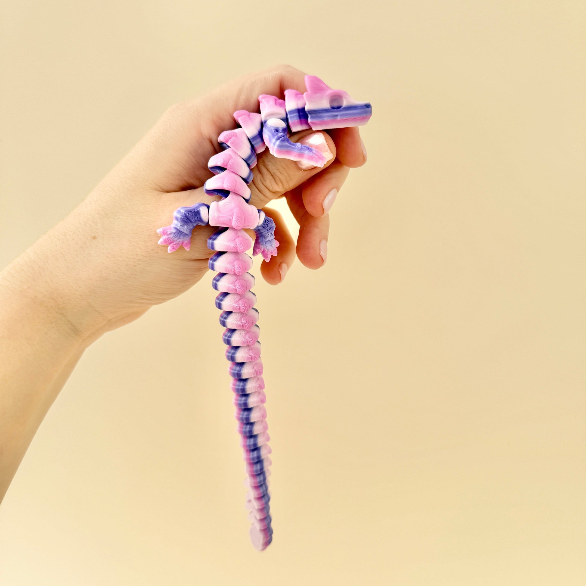 Skeleton Dragon fidget toy in a soft purple and lilac gradient with bone-inspired details.