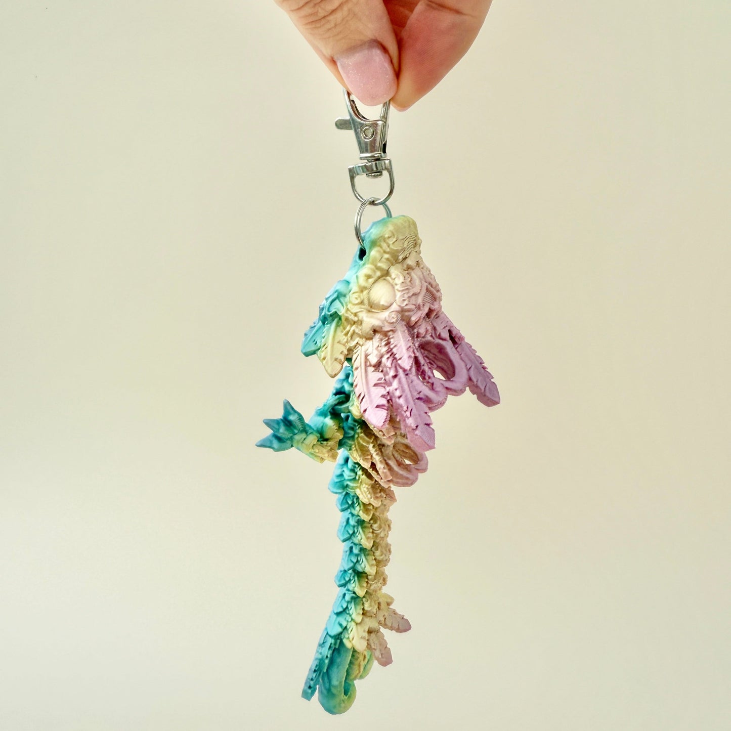 Shiny rainbow-coloured Heart Dragon Tadling keyring with fully articulated body and detailed design.