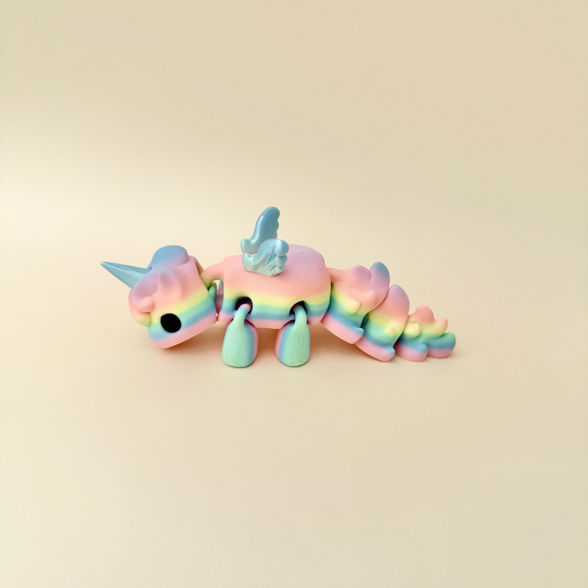 Large Unicorn fidget toy in rainbow gradient with shimmering iridescent wings and horn.