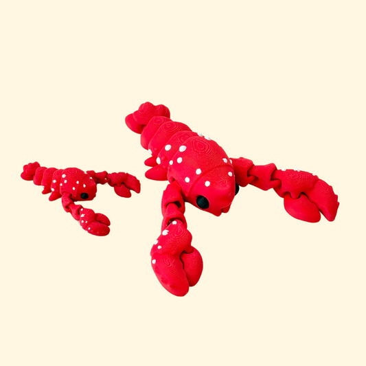 Red lobster fidget with movable parts, white dots, and black eye, great for collectors.