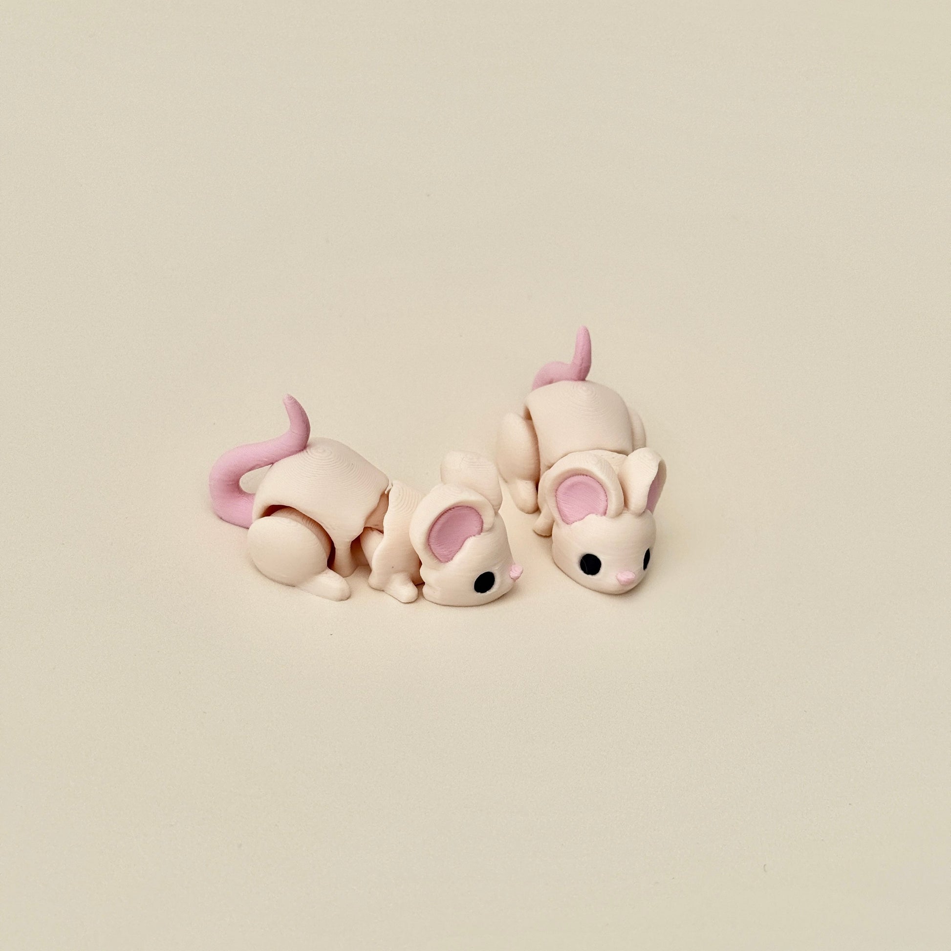 Realistic beige mouse fidget toy with flexible joints, featuring pink ears, nose, and tail for tactile engagement.