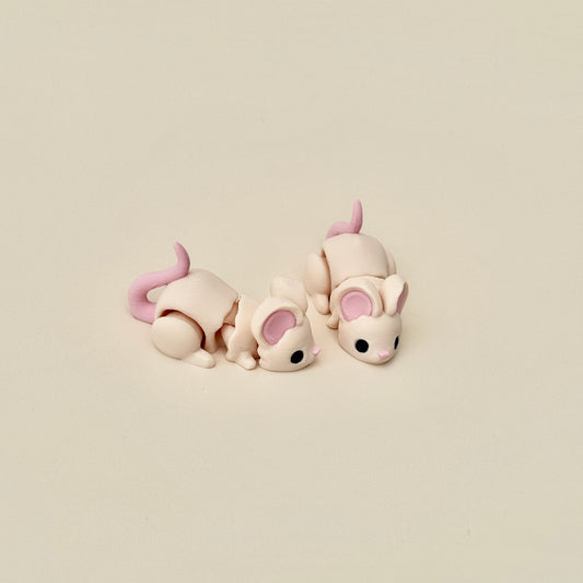 Realistic beige mouse fidget toy with flexible joints, featuring pink ears, nose, and tail for tactile engagement.