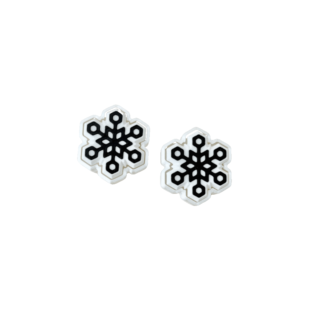 White snowflake clicker fidget toy with black snowflake design, just under 4cm, perfect for sensory play.