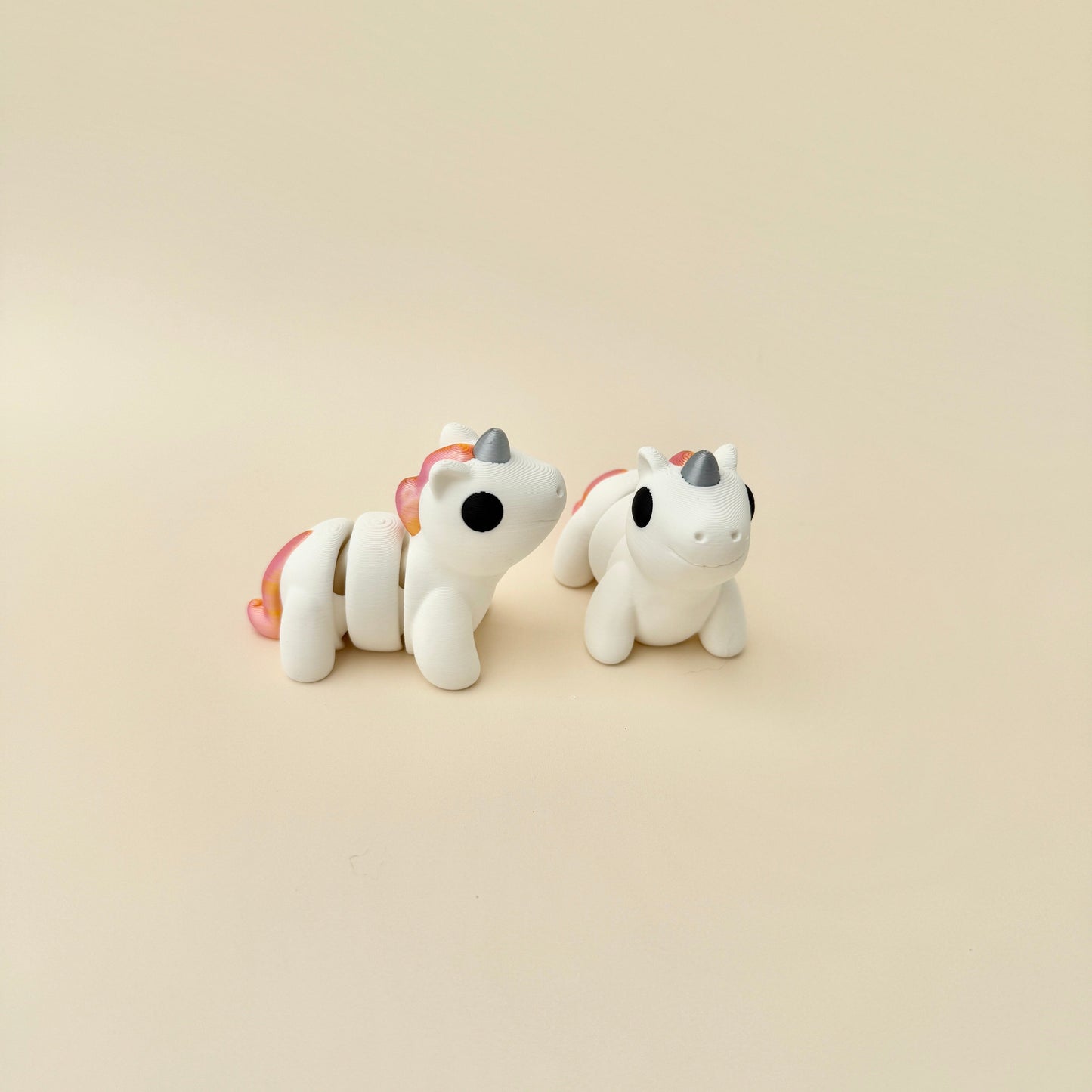 Fully articulated Dreamhoof unicorn fidget toy with a white body and shimmering details.