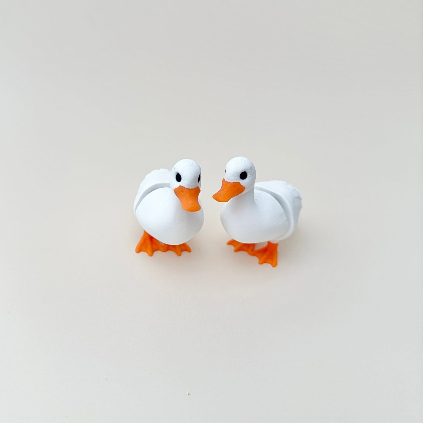 Exclusive white duck fidget toy with orange beak and legs, able to stand up on its own, perfect for tactile engagement.

