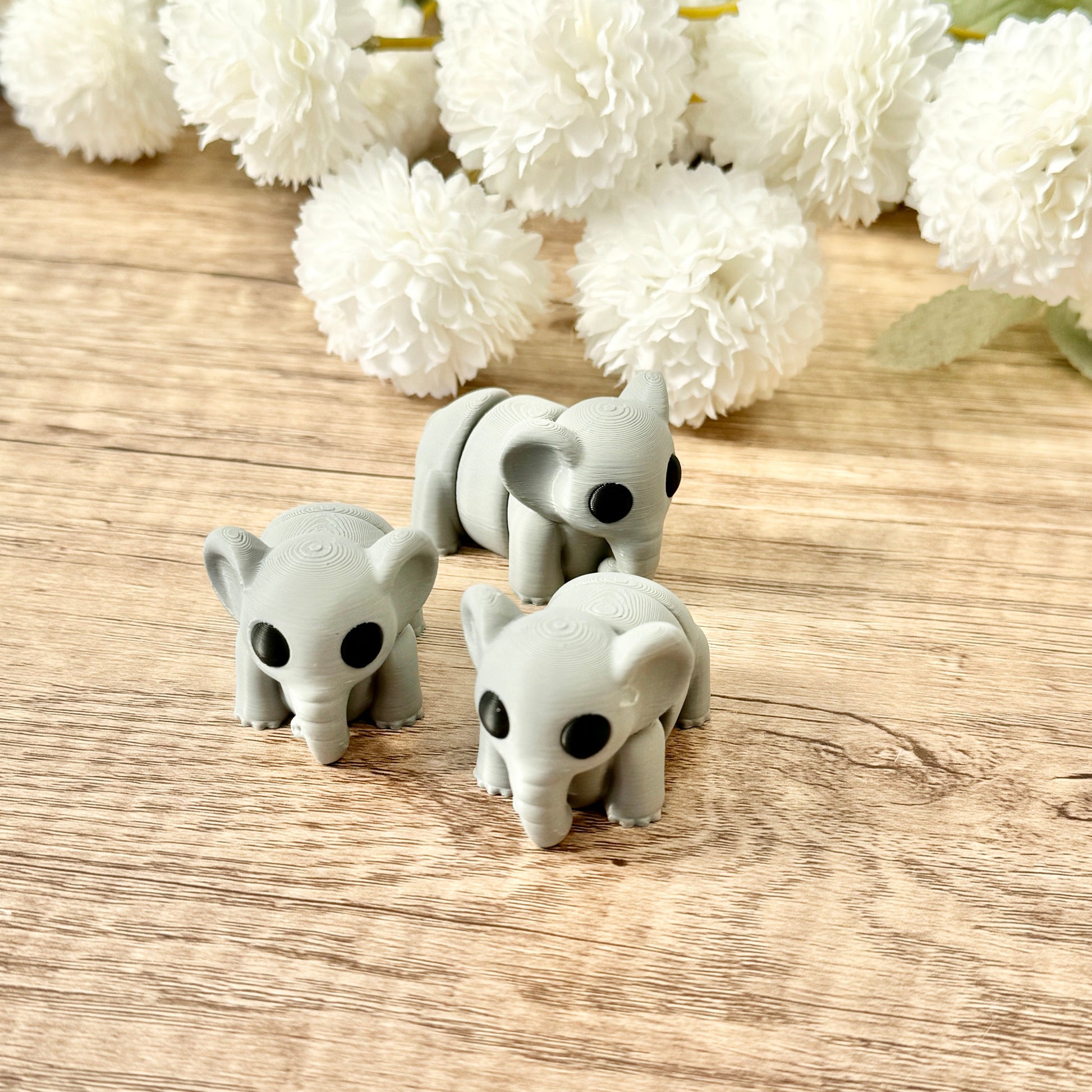 5.5 cm grey elephant fidget toy with black eyes, fully articulated for wiggling and sensory play.