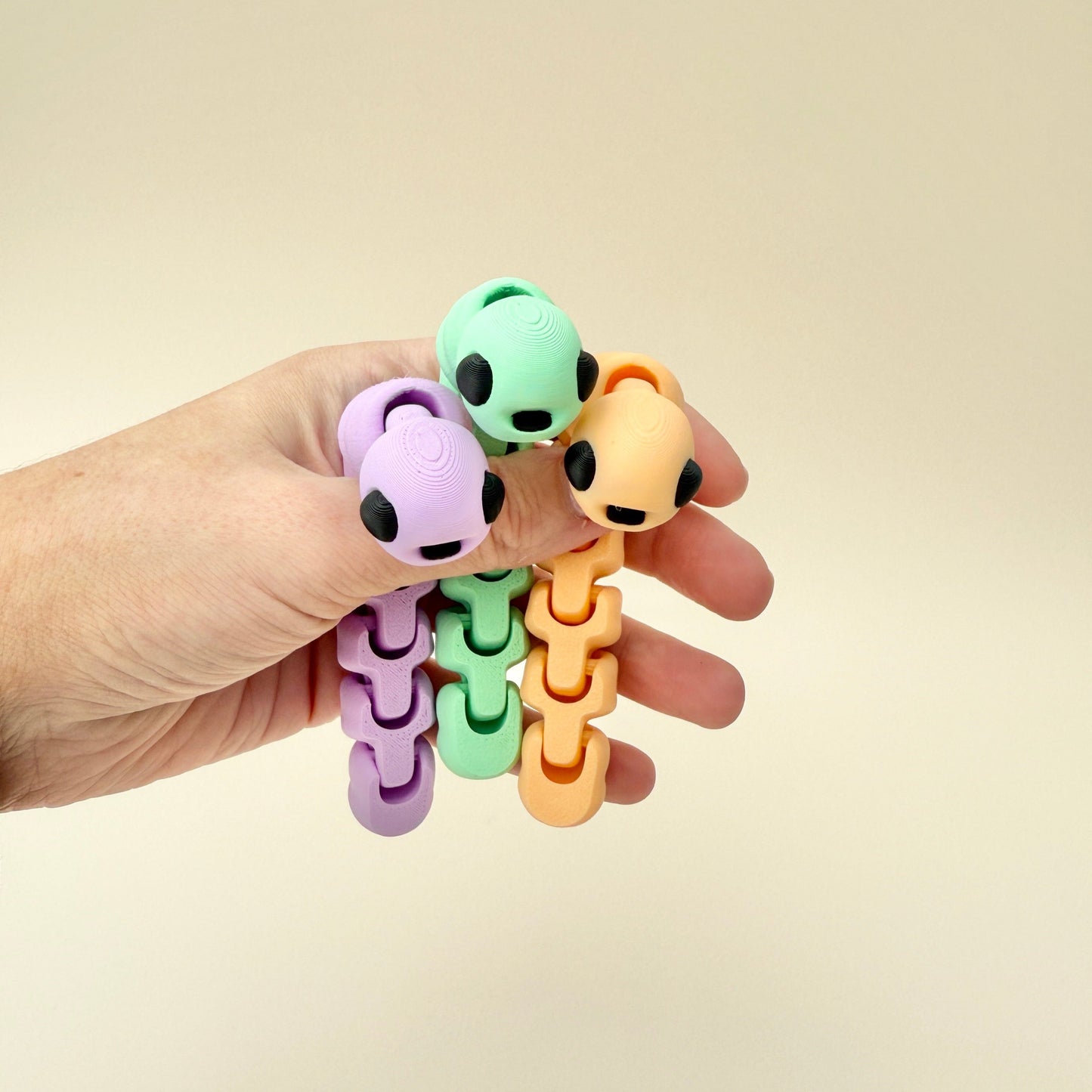 Worm fidget toy with an optional apple container, great for on-the-go play and storage.