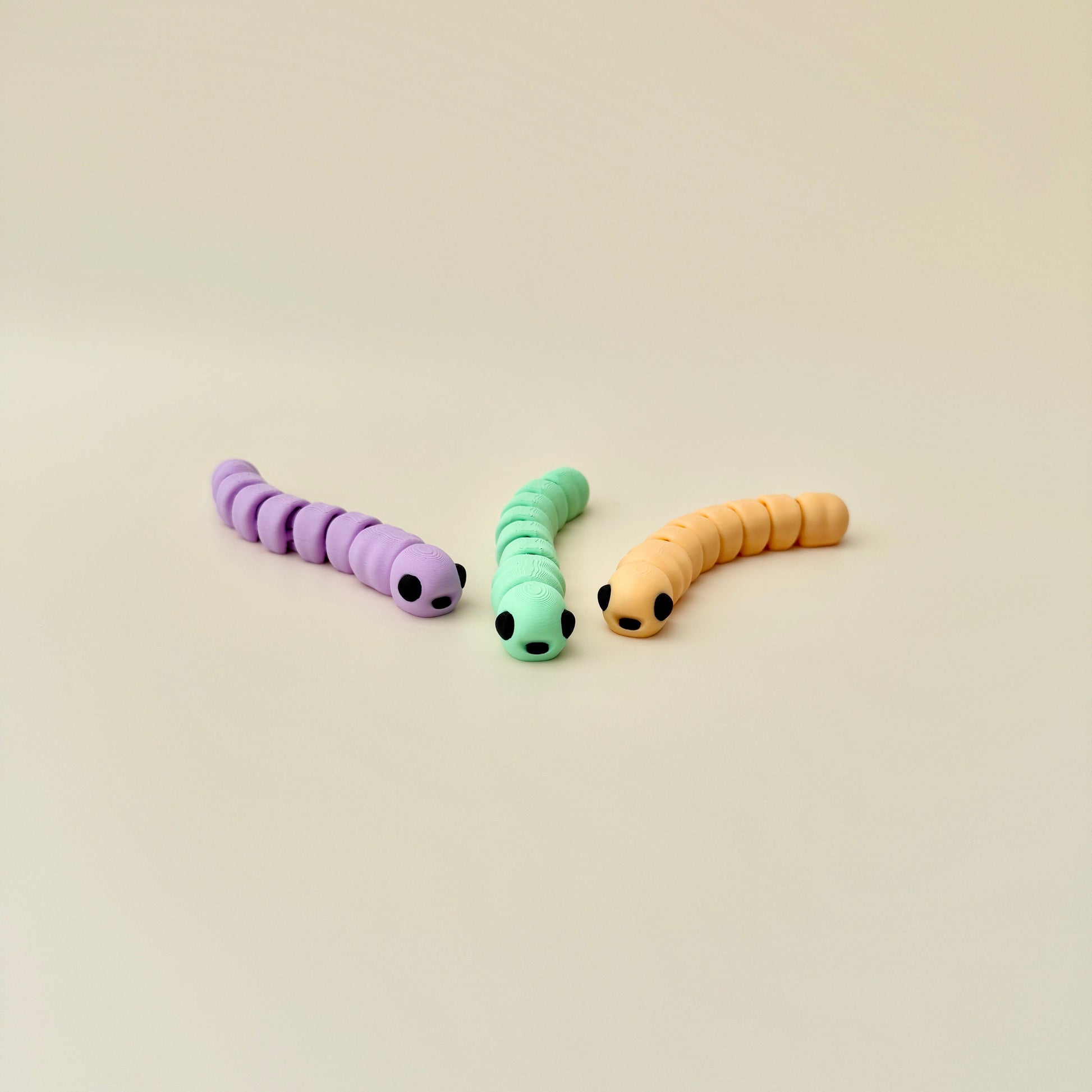 Worm fidget toy with a small apple container, a fun add-on option for play and portability.

