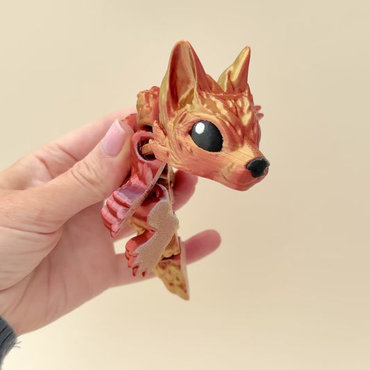 Stunning Wolf Pup Dragon in colour-shifting filament with dynamic gold, silver, and copper tones.