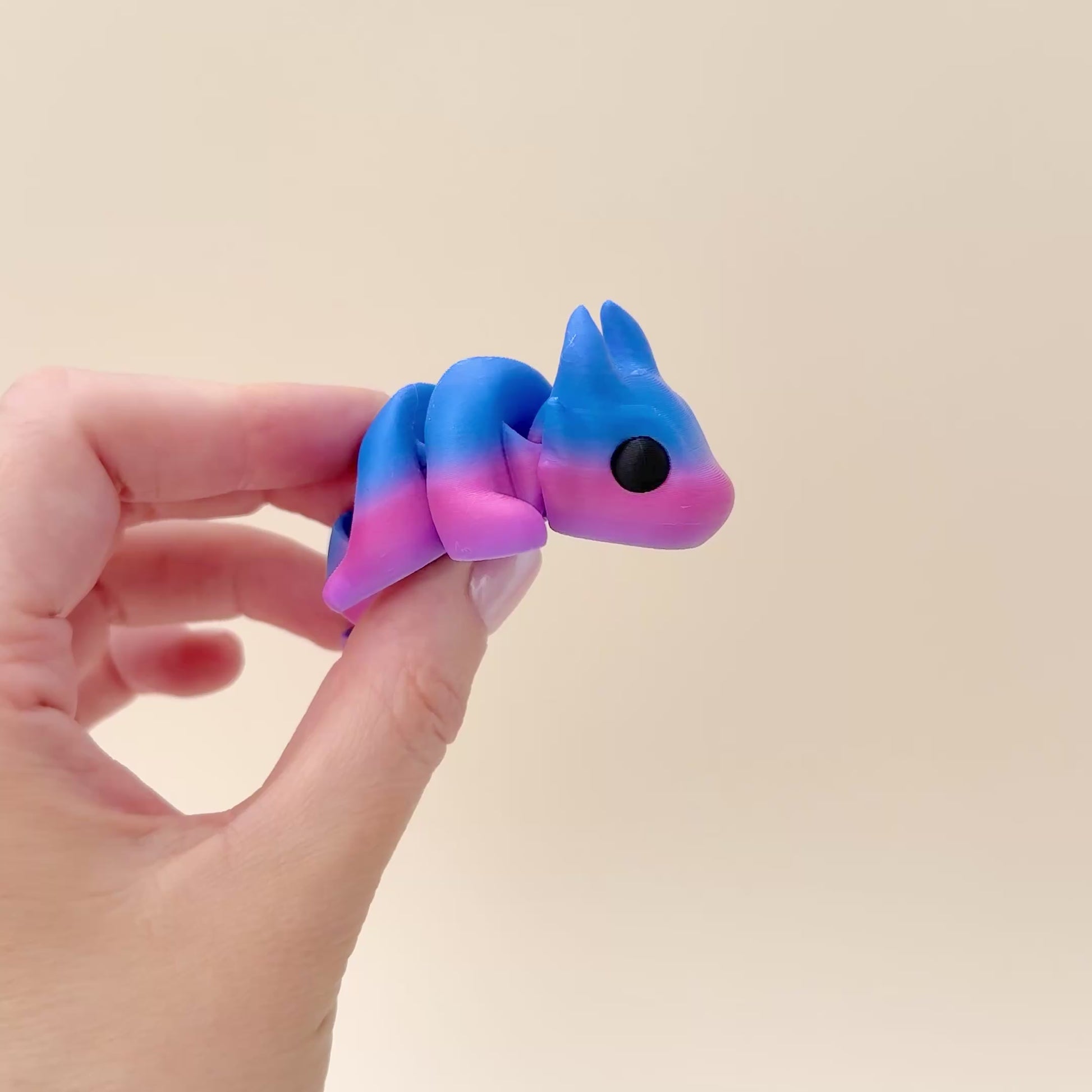 Baby Dragon fidget toy in a purple and blue gradient with flexible movement and magical dragon details.