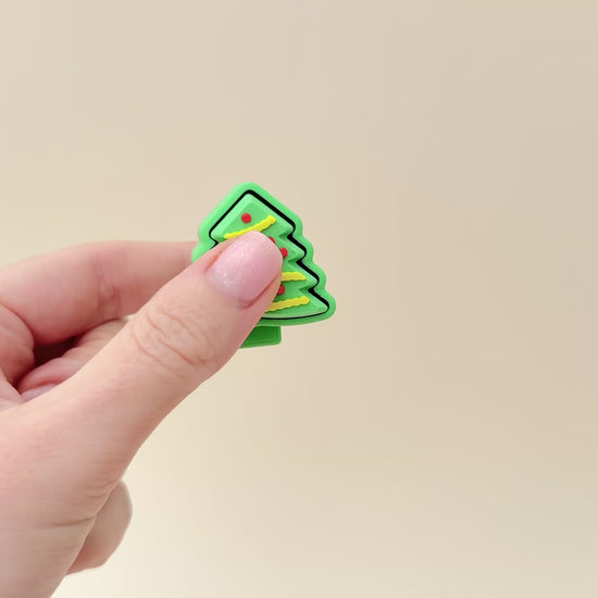 4cm Christmas tree clicker toy with festive detailing and a smooth clicking motion for tactile fun.