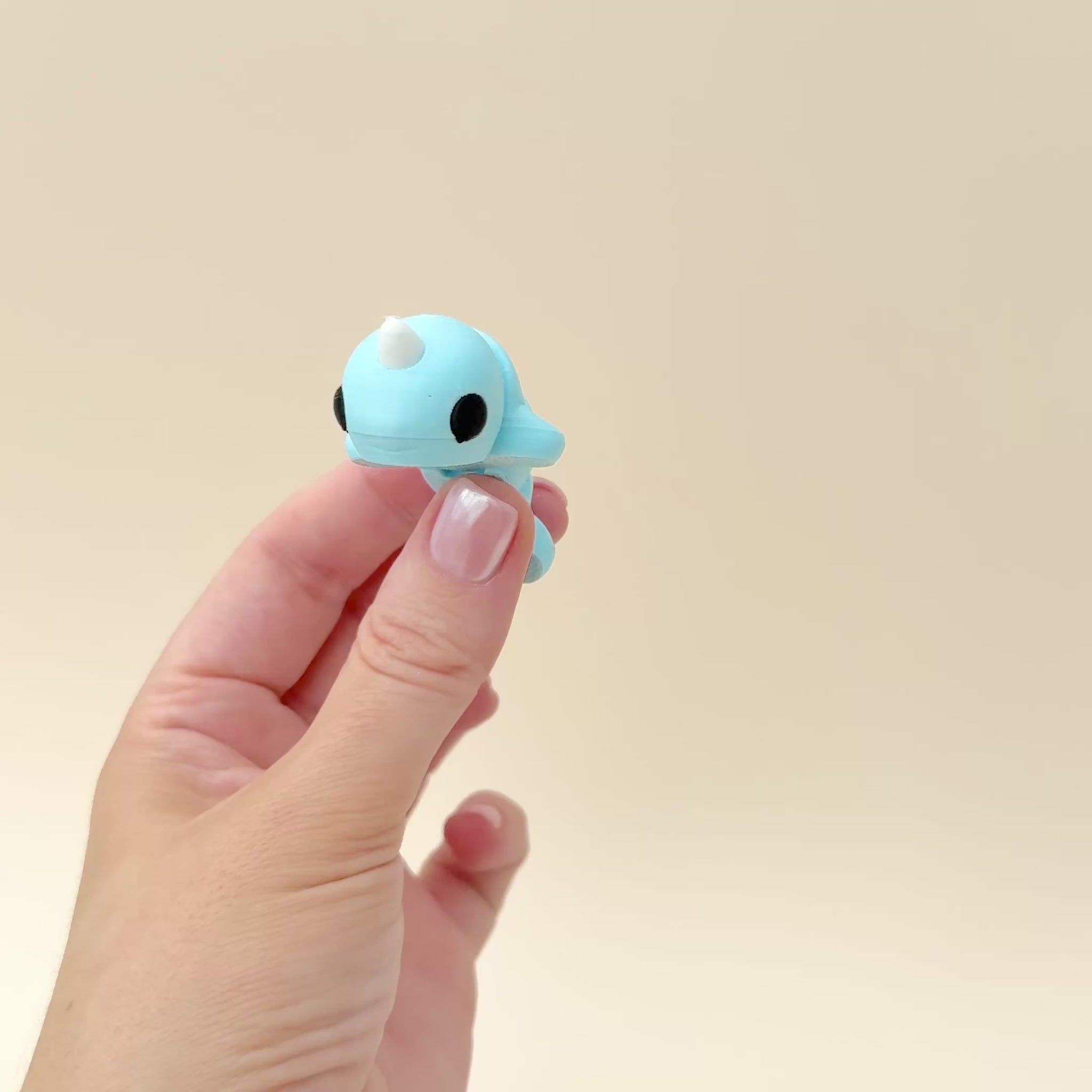 5.5cm light blue narwhal fidget toy with a white horn and charming design.