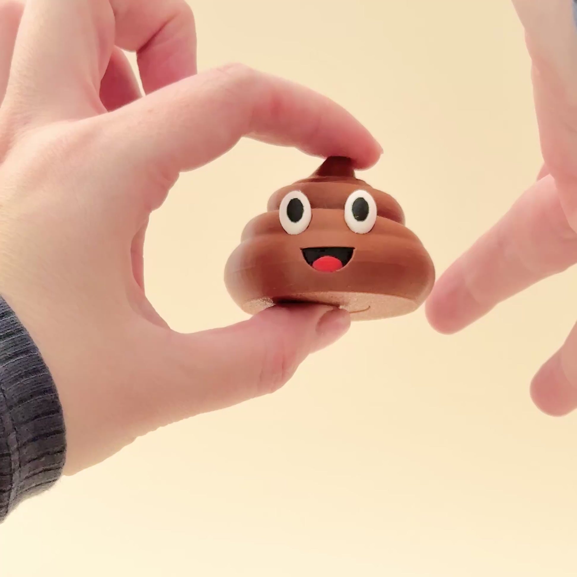 Poop spinner in brown with realistic emoji details, designed for fun and sensory engagement.