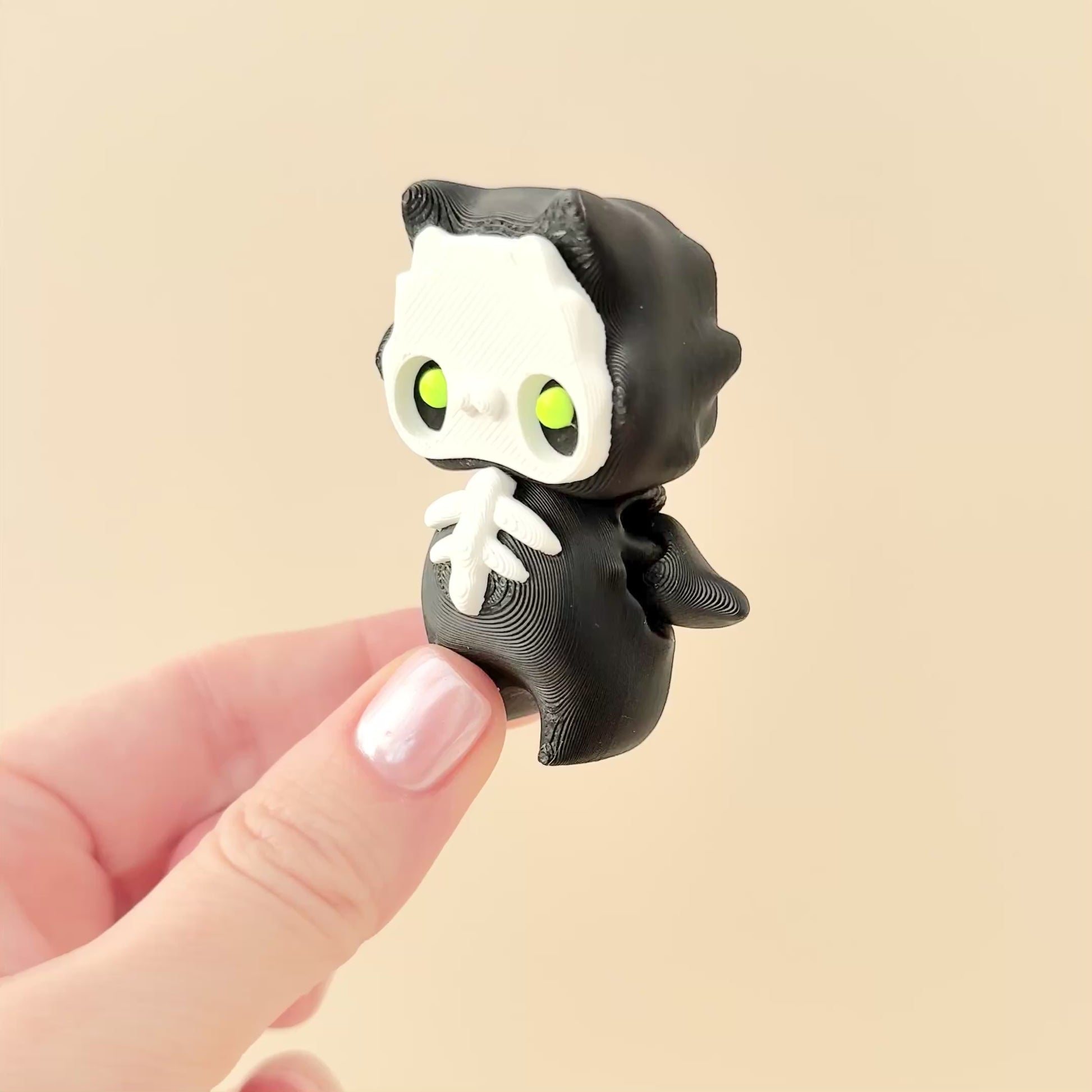 Flexible Pixie-Skelly fidget toy in black, white, and lime green for sensory play.