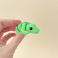 Fully articulated crocodile fidget toy with a vibrant green design and realistic black eyes.